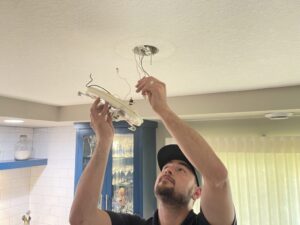 deans technician installing a light fixture