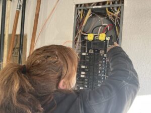 deans electrian working from the electrical panel