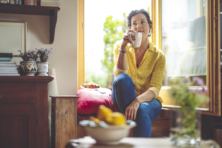 woman having coffee in her cool home summer