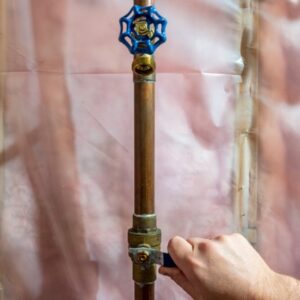 Copper pipe that is an example of a home's main water supply showing how to turn it off