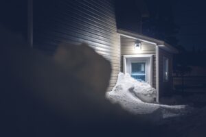 Home covered in snow, that's blocking door at night