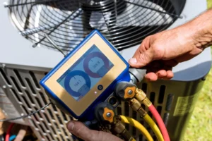 A professional hvac technician inspecting an ac unit by measuring refrigerant levels.